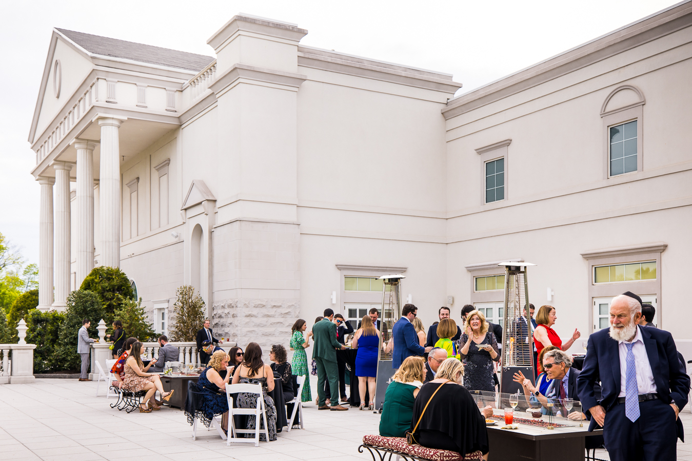 palace at somerset wedding photographer, lisa rhinehart, captures the stunning view of the palace from outside as guests mingle with one another outside on the patio 