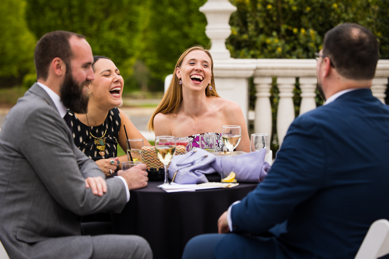 new jersey wedding photographer, lisa rhinehart, captures this authentic, candid moment of the guests as they mingle and laugh with one another during cocktail hour outside of the palace at somerset park 