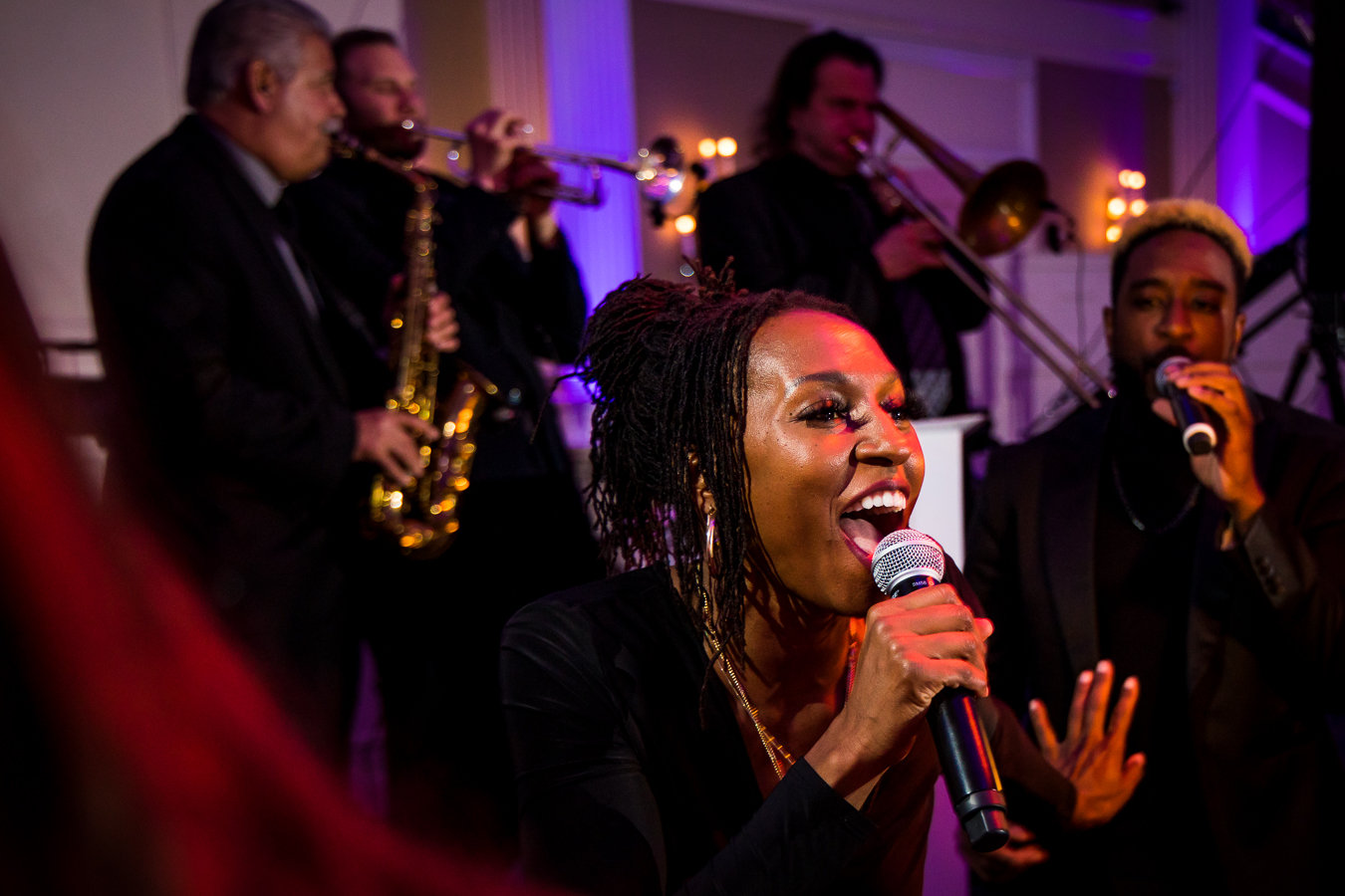 creative NJ Wedding Photographer, lisa rhinehart, captures this creative, unique image of the live band from the wedding with the singer front and center 