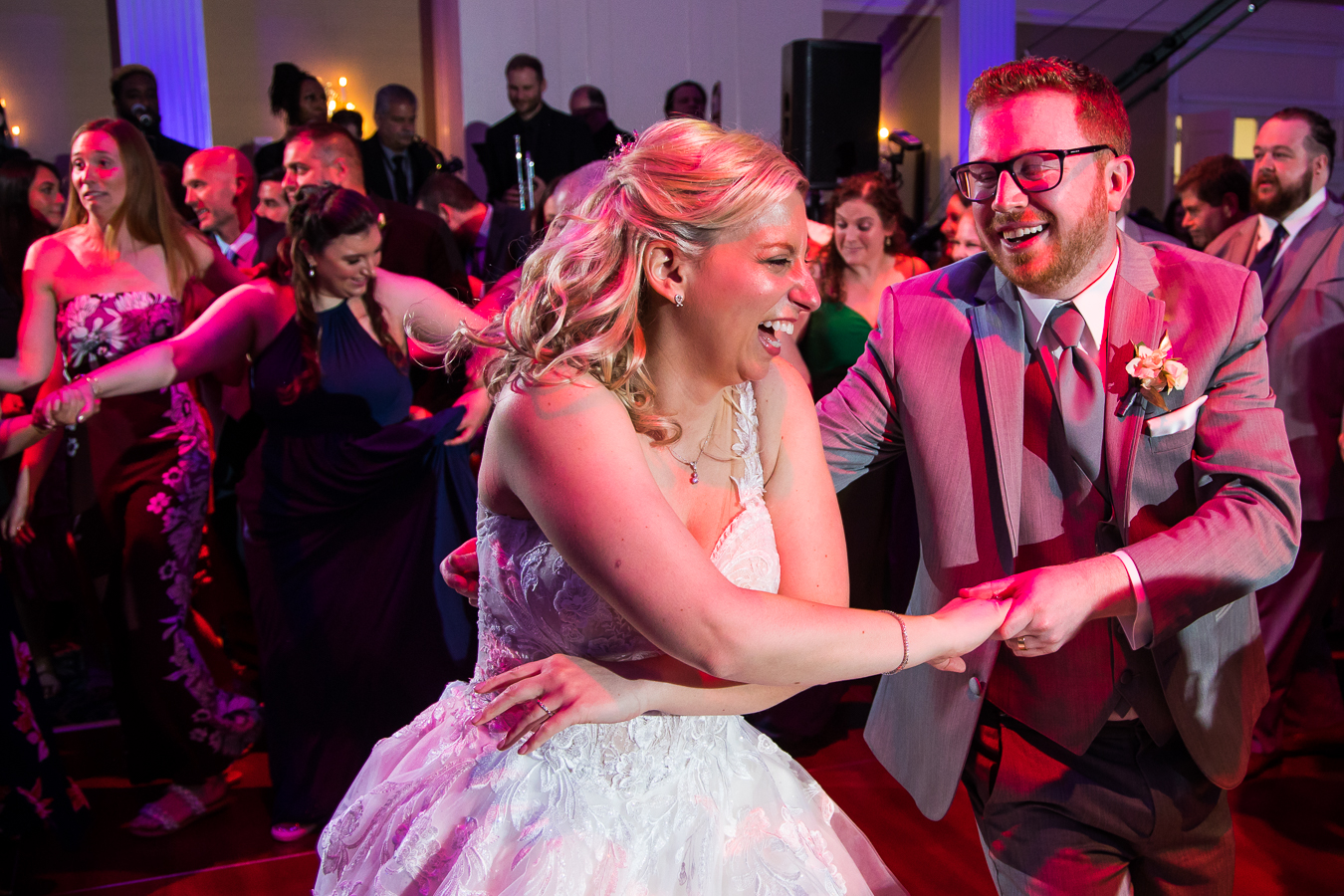 new jersey wedding photographer, rhinehart photography, captures this fun, candid image of the bride and groom as they dance together with one another during their wedding reception at the palace 
