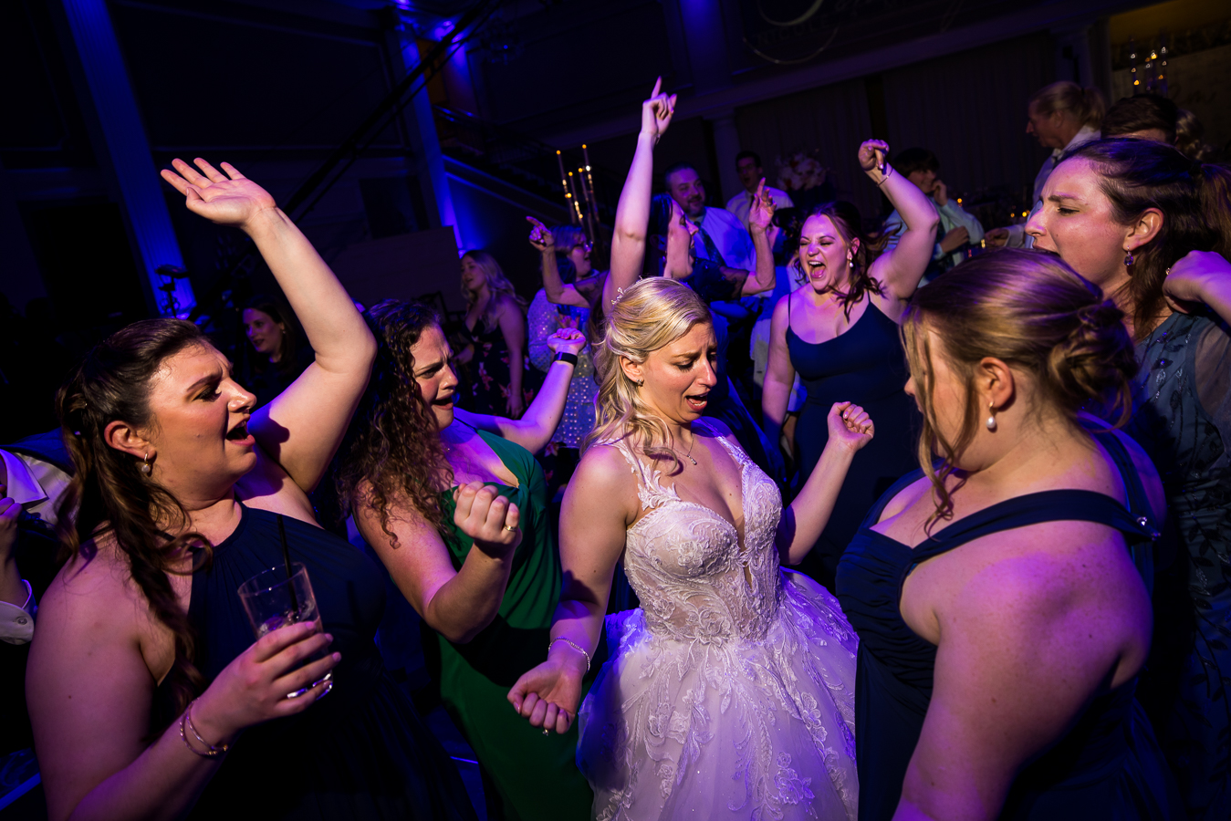  lisa rhinehart, captures this fun, creative angle of the bride as she dances with her friends and wedding guests