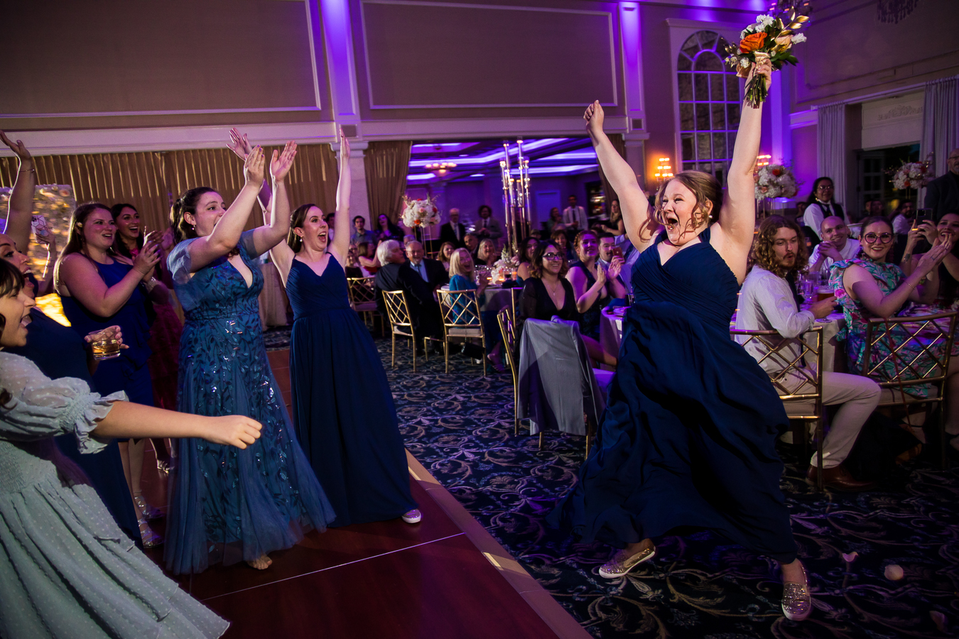 authentic wedding photographer, lisa rhinehart, captures this fun, authentic image of a bridesmaids reaction to catching the bouquet 