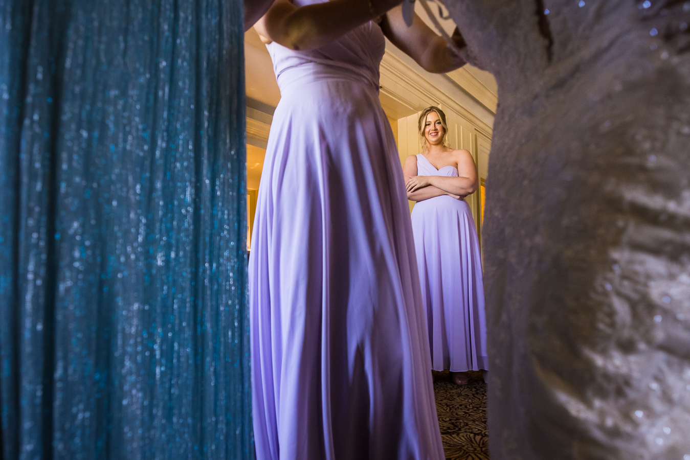 unique perspective of a bridesmaid as she watches the bride get ready before her wedding ceremony in york pennsylvania