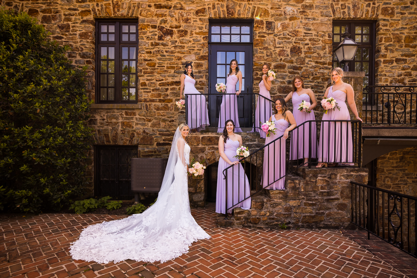 creative wedding photograper, lisa rhinehart, captures this unique image of the bride with her bridesmaids standing on the stairway during their bridal party portraits outside of the country club