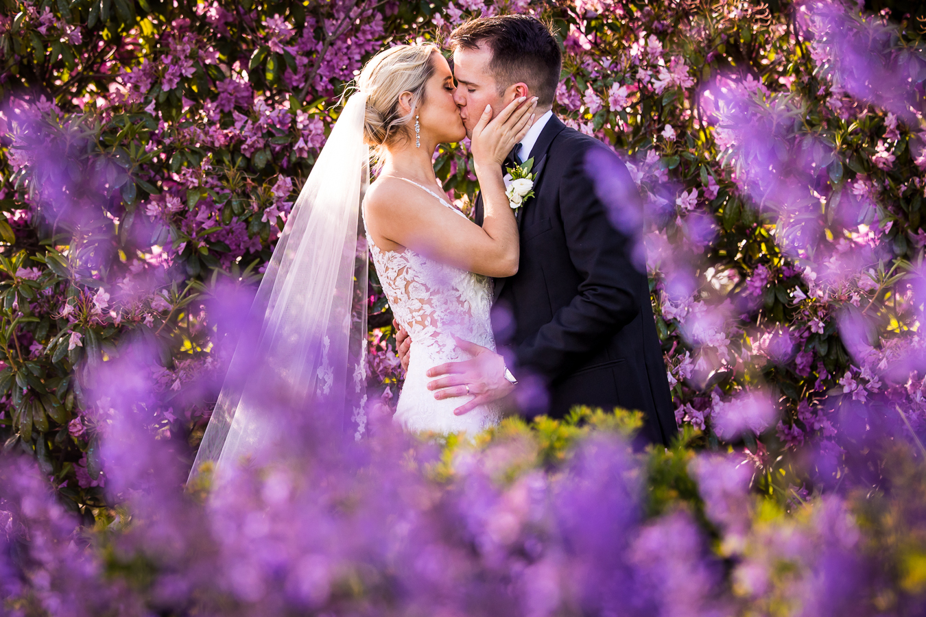 Country Club of York Wedding photographer, lisa rhinehart, captures this creative, vibrant and colorful image of the bride and groom as they kiss during their wedding portraits