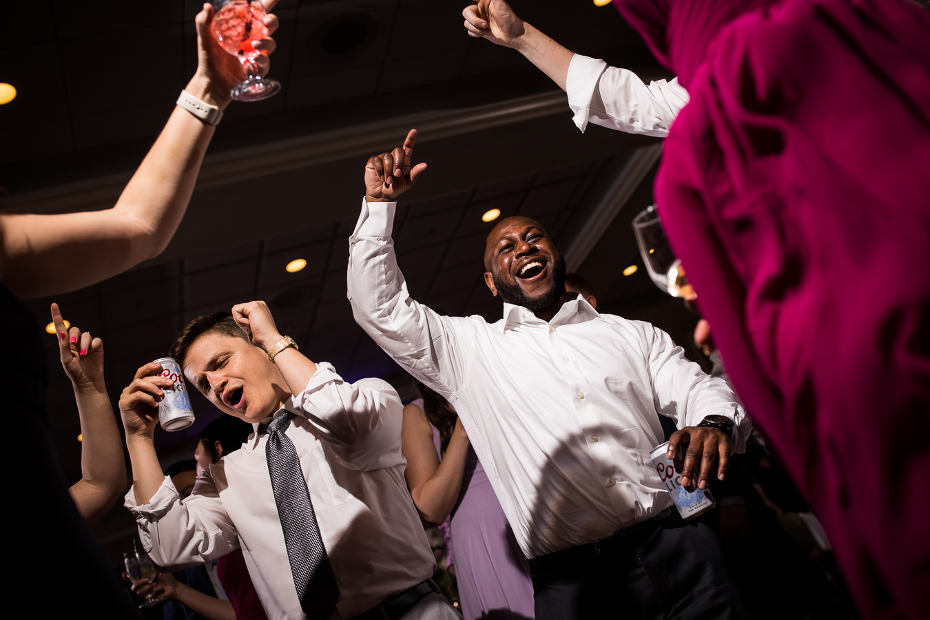 creative wedding photographer, rhinehart photography, captures this unique perspective of guests dancing with their hands in the air during this wedding reception in york 