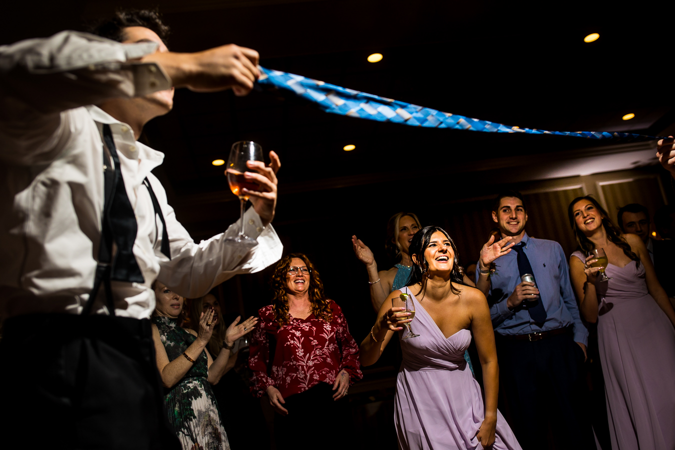 image of guests playing limbo on the dance floor with their ties