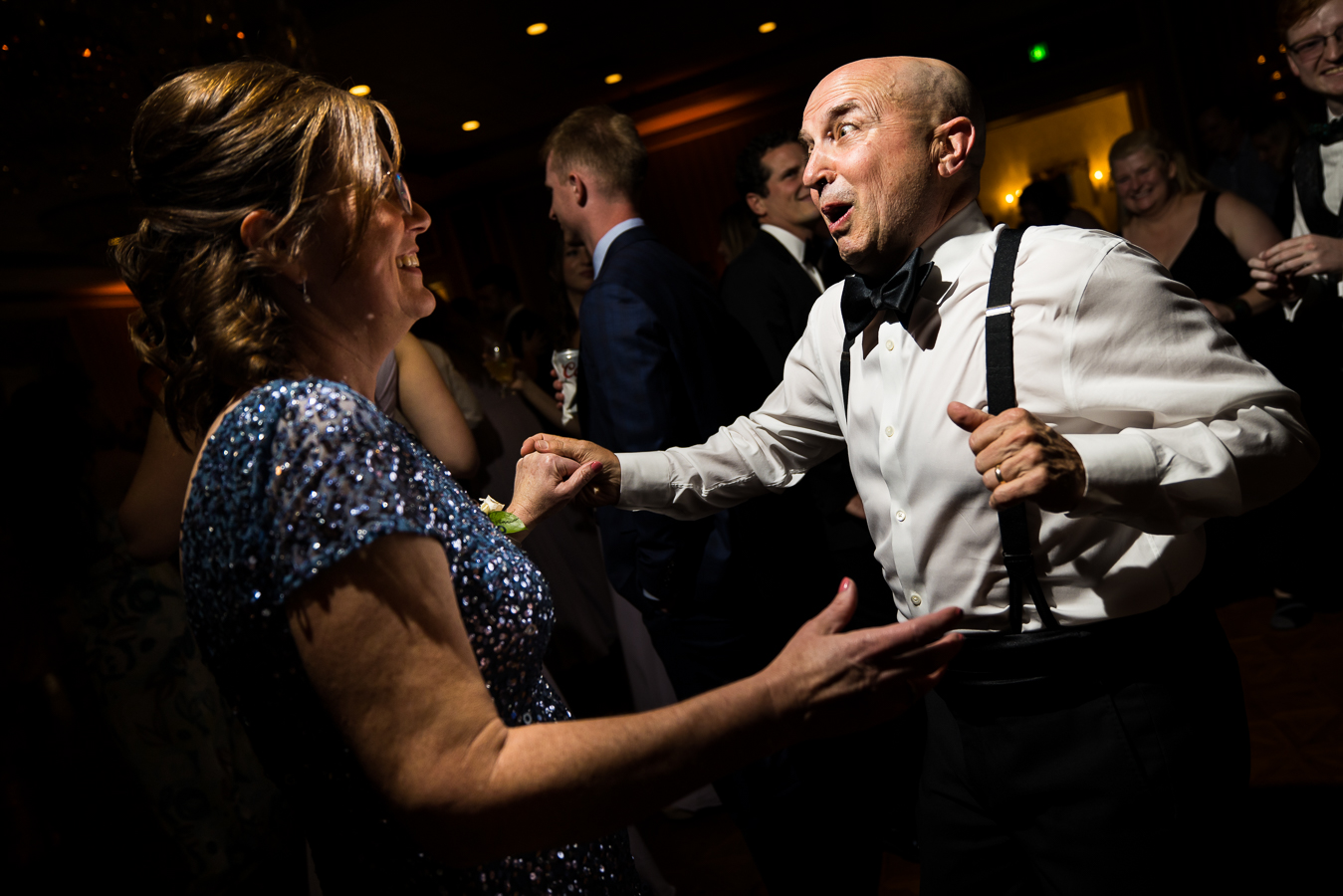 creative, fun wedding photographer, lisa rhinehart, captures this fun image of the grooms mother and father dancing together on the dance floor