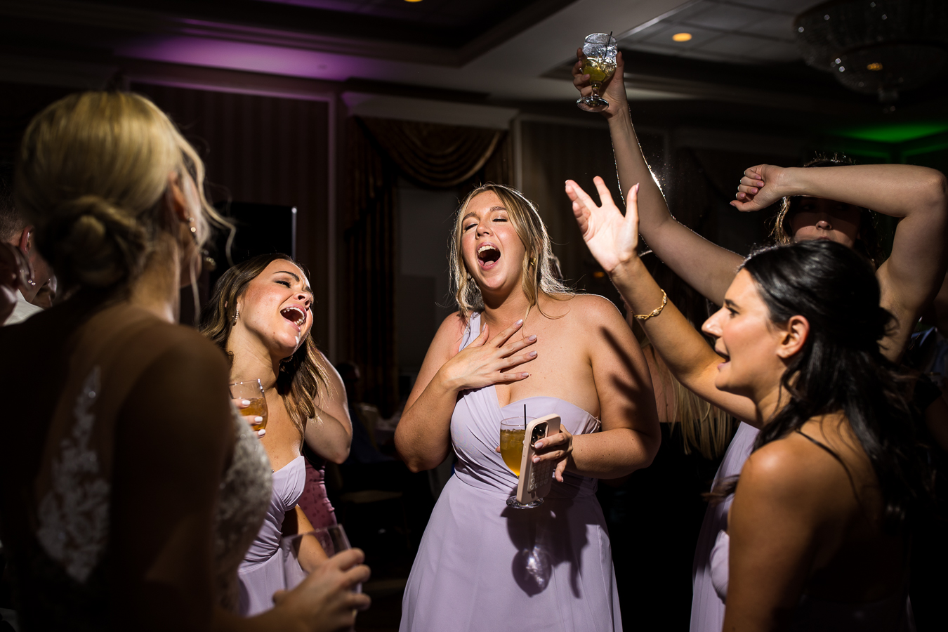 image of the bride and her bridesmaids dancing and singing together at this country club of york wedding