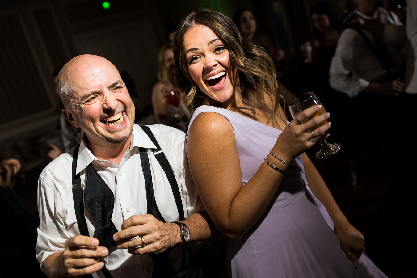 image of the dad and a bridesmaid dancing together 