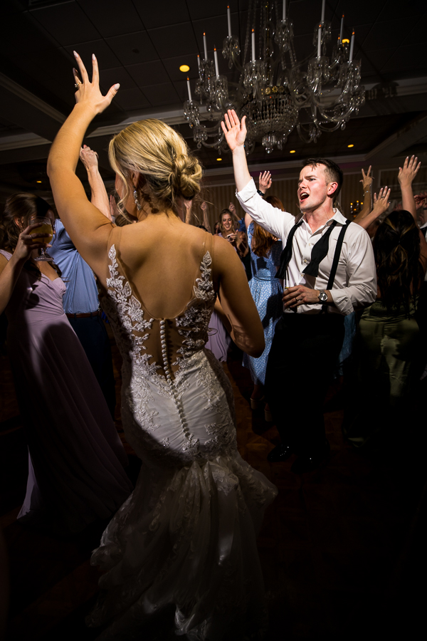 creative, fun image of the bride and groom dancing together with their guests at their wedding reception in york 