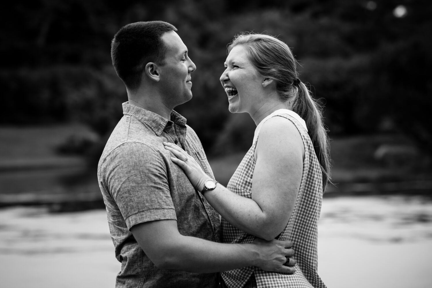 traditional proposal photographer, lisa rhinehart, captures this black and white image of the couple as they are smiling from ear to ear after their proposal inside the Missouri botanical gardens in st louis missouri