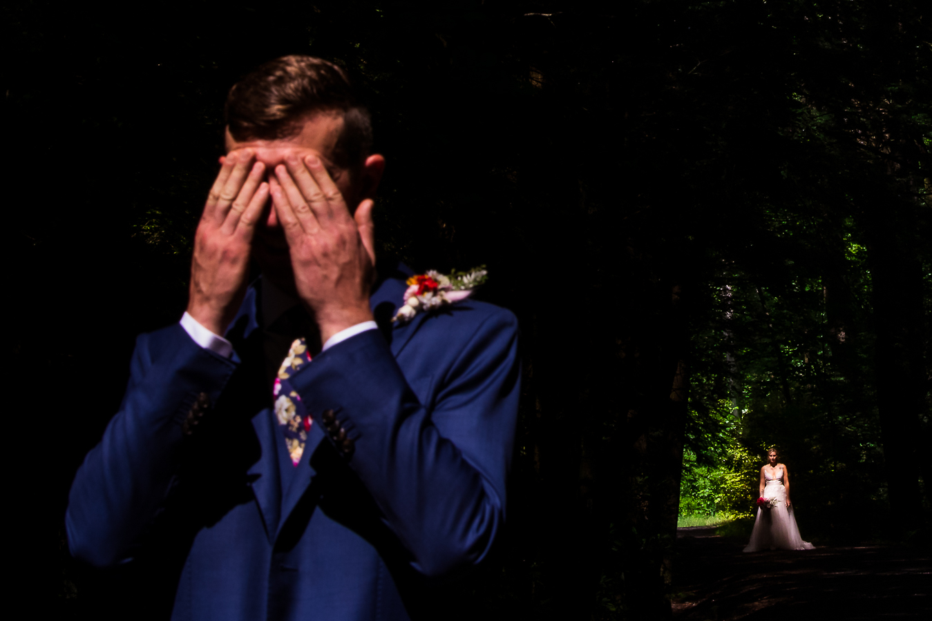 wedding photographer, lisa rhinehart, captures this image of the groom covering his eyes as the bride walks up behind him to share their first look together on the hiking trail in pa 