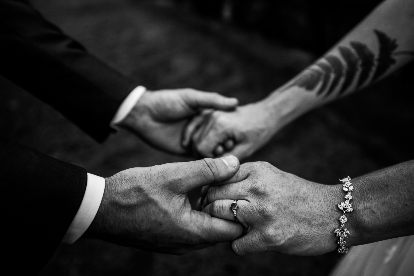 black and white image of the bride and groom as they hold hands with one another after seeing each other during their first look 