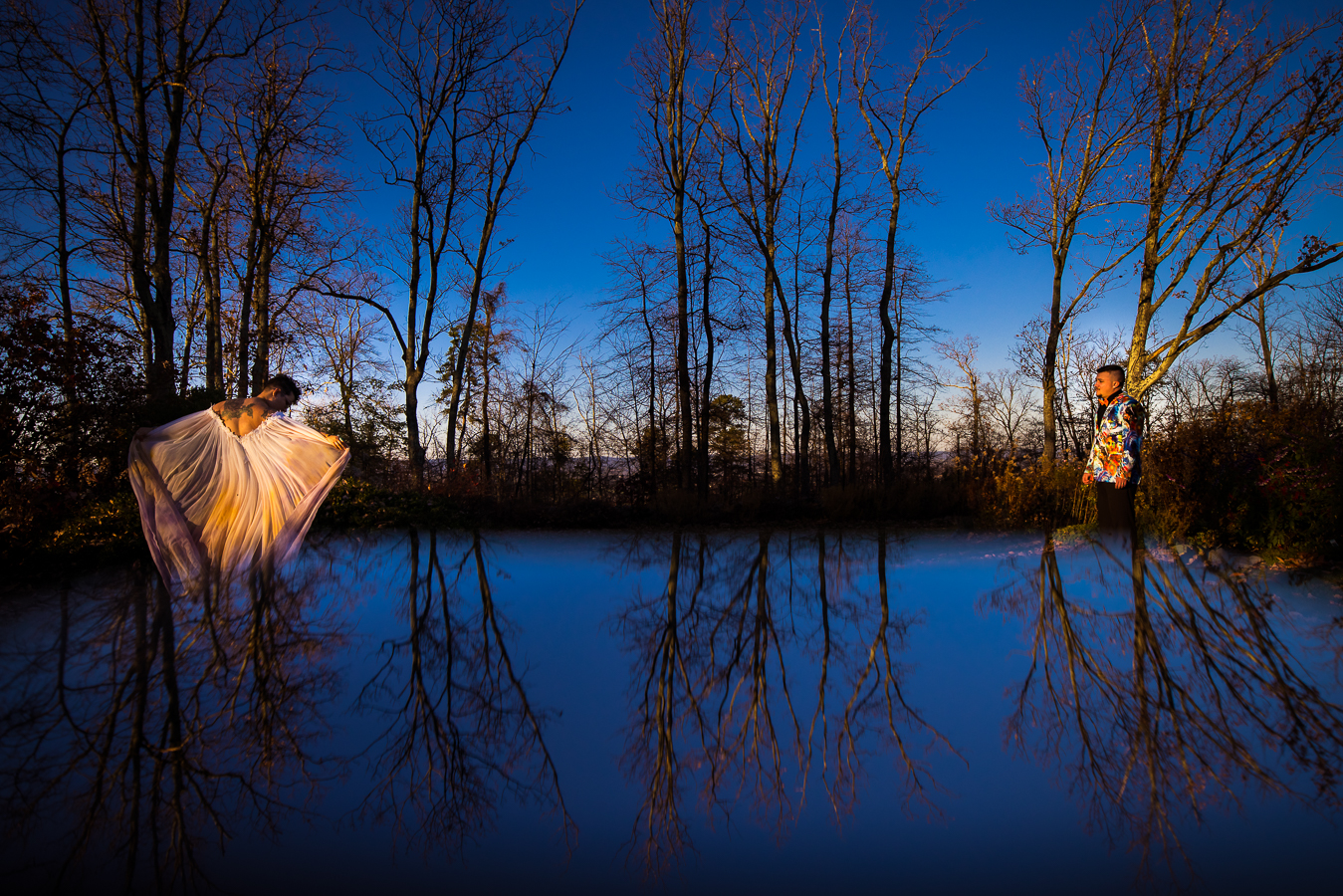 Creative LGBTQ Wedding Photographer, lisa rhinehart, captures this vibrant, colorful, creative image of the couple in nature with their reflection s captured as well