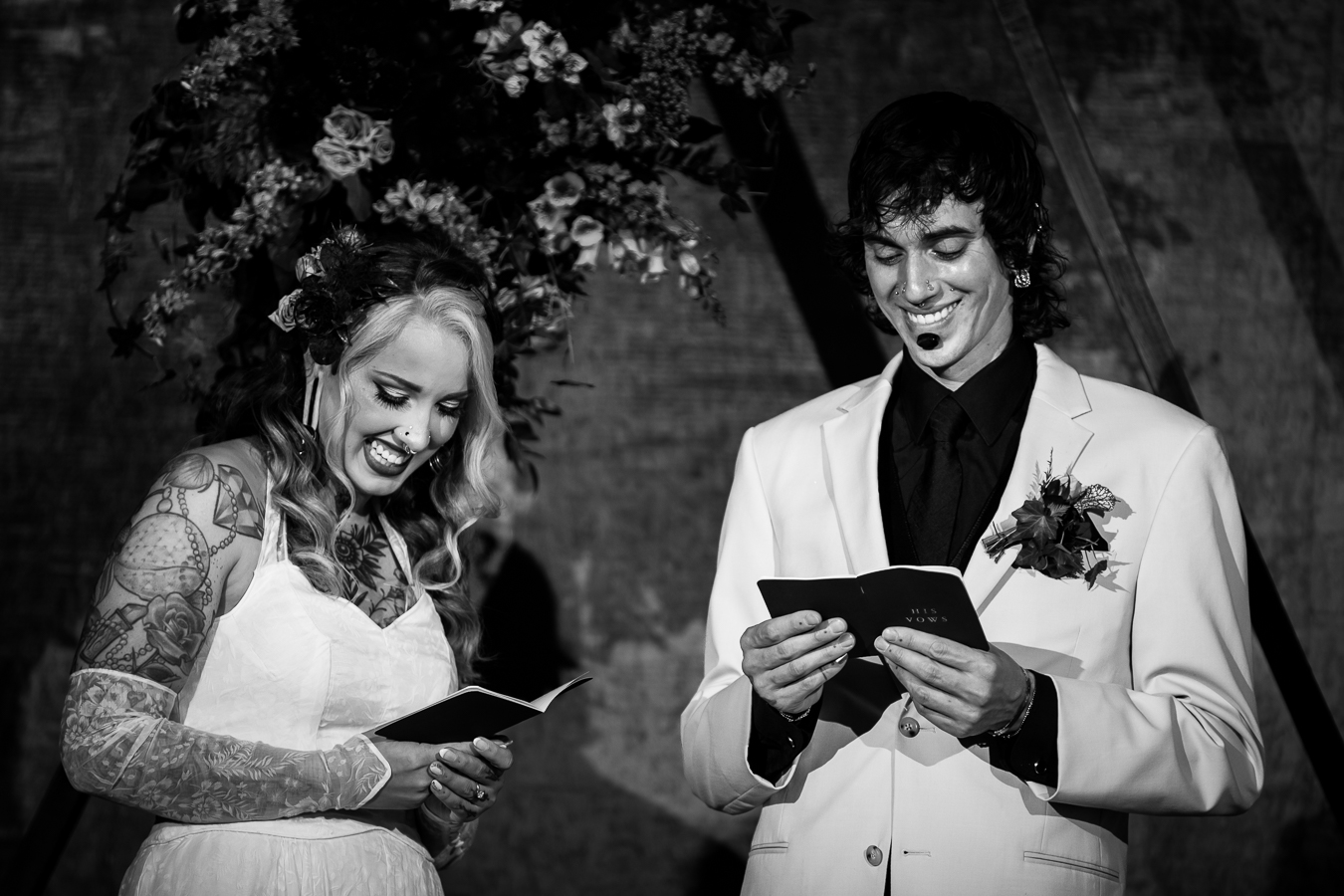 Cork Factory Hotel Wedding Photographer, lisa rhinehart, captures this authentic, candid black and white image of the couple laughing and smiling as they share their vows with each other during their wedding ceremony 