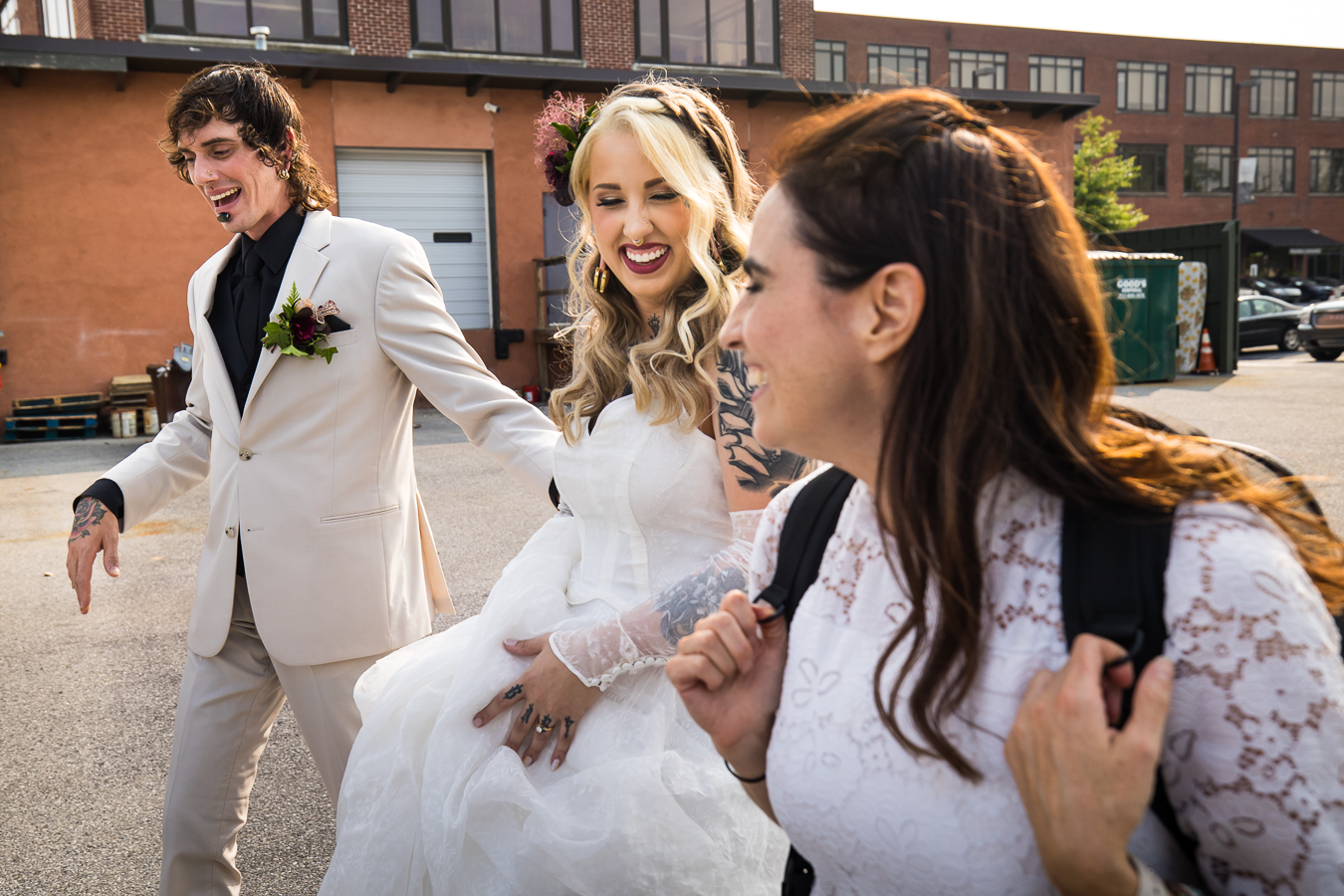 behind the scenes image of lisa rhinehart walking with eleanor and sam to capture romantic portraits after their wedding ceremony 