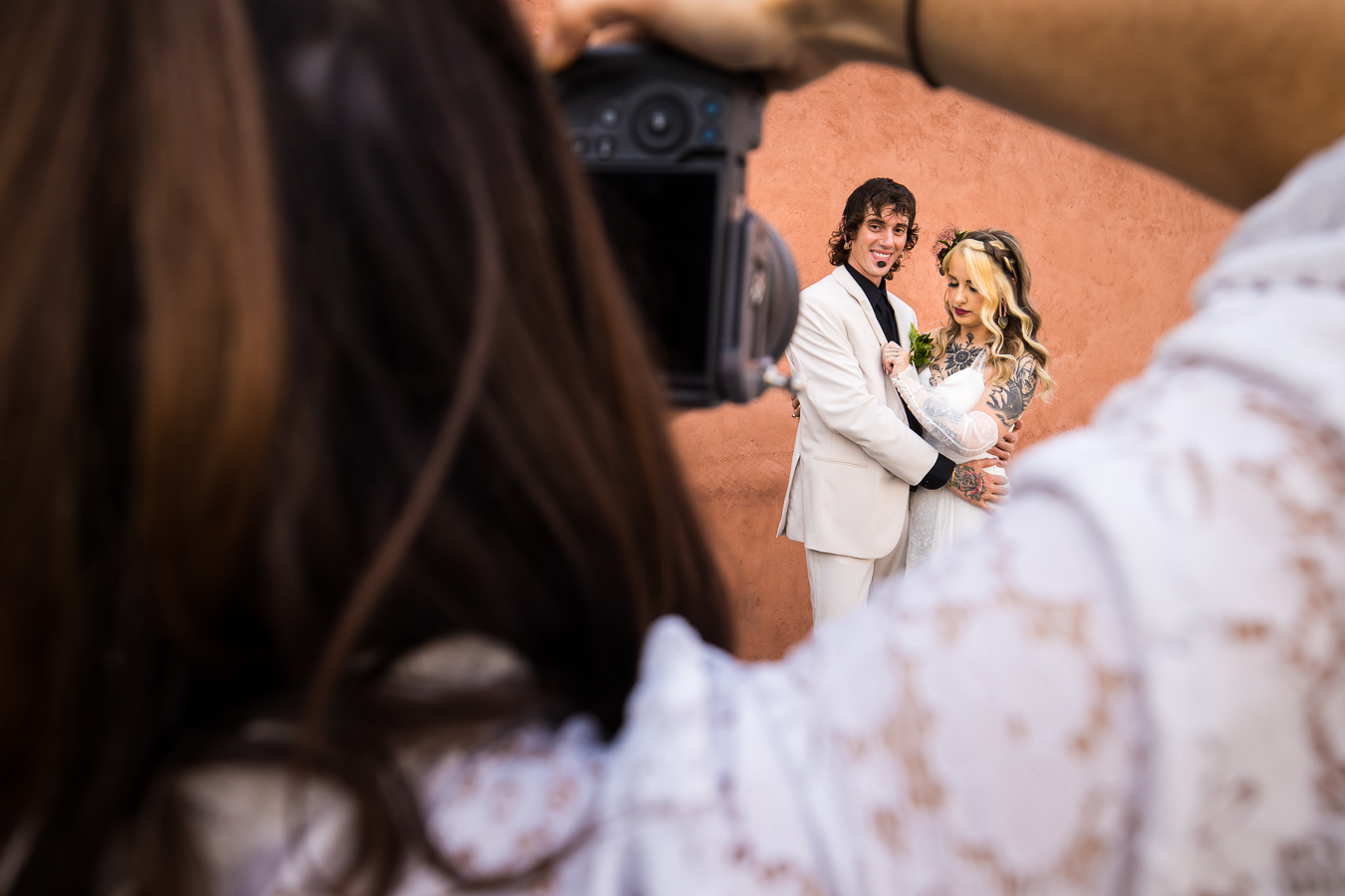 behind the scenes image of lisa Rhinehart capturing the bride and groom during their romantic portrait session outside of the hotel 