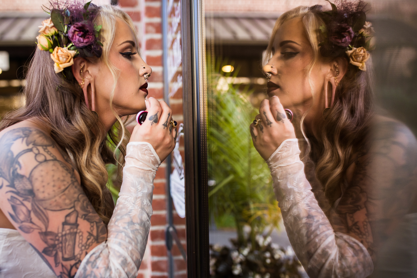 this creative Cork Factory Hotel Wedding Photographer captures a creative, reflection image of the bride as she looks at herself in the window before her wedding reception 