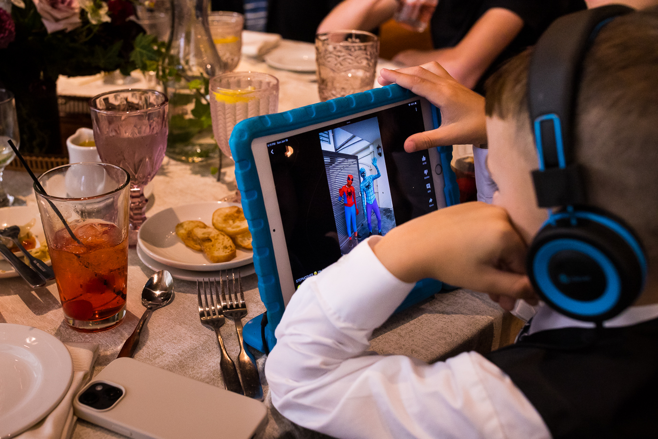 image of the kids at the wedding enjoying some tiktok videos on their ipad