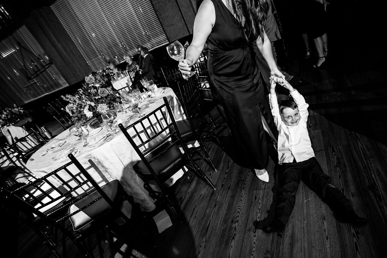 black and white image of the boy being dragged across the floor during the reception