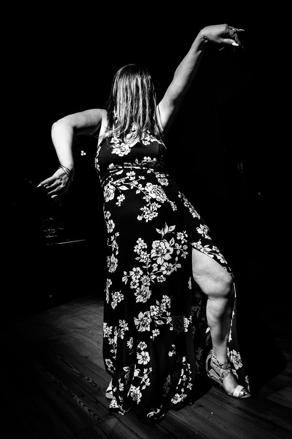 black and white image of a guest dancing and having fun during the reception 