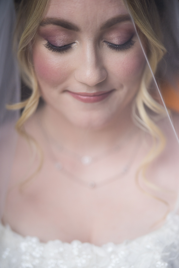Lisa Rhinehart captures this creative, unique portrait of the bride as she looks down with her veil in front of her face before her ceremony in new hope pa