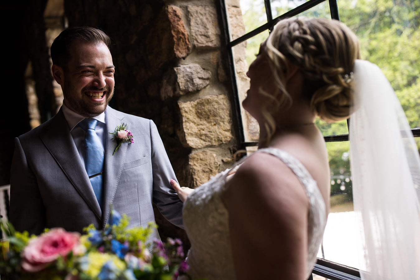 Holly Hedge Estate Wedding Photographer, lisa rhinehart, captures the bride and groom as they smile and laugh at each other during their unique indoor first look 