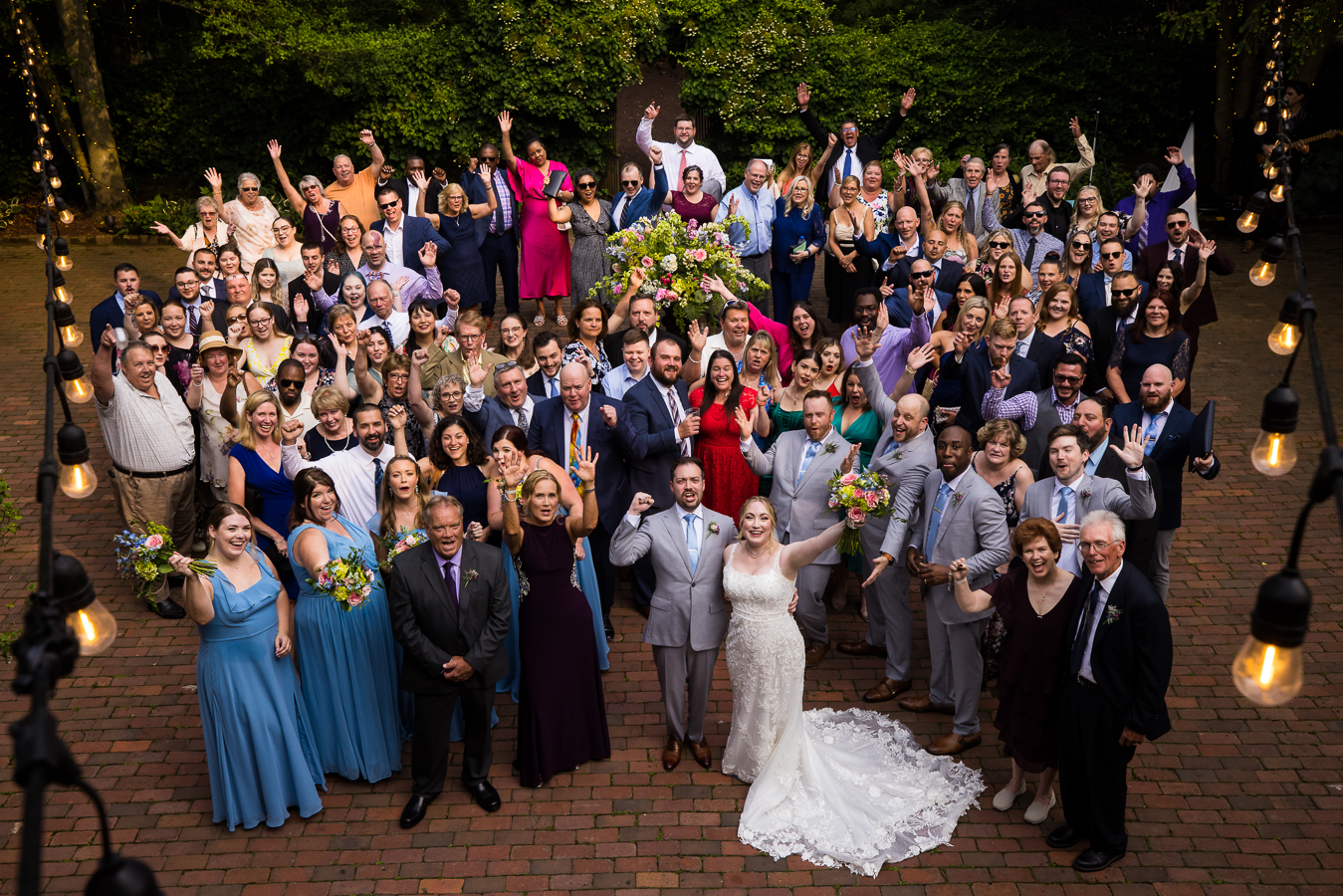 pa wedding photographer, lisa rhinehart, captures this big group shot of the bride and groom with their family and friends after their wedding ceremony 