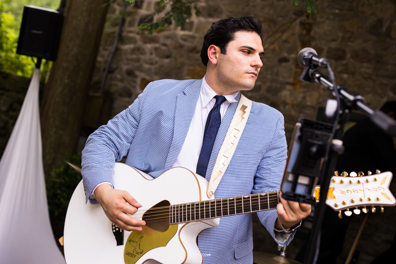 image of galavant entertainment playing the guitar as they get ready for their wedding ceremony at hollyhedge estate