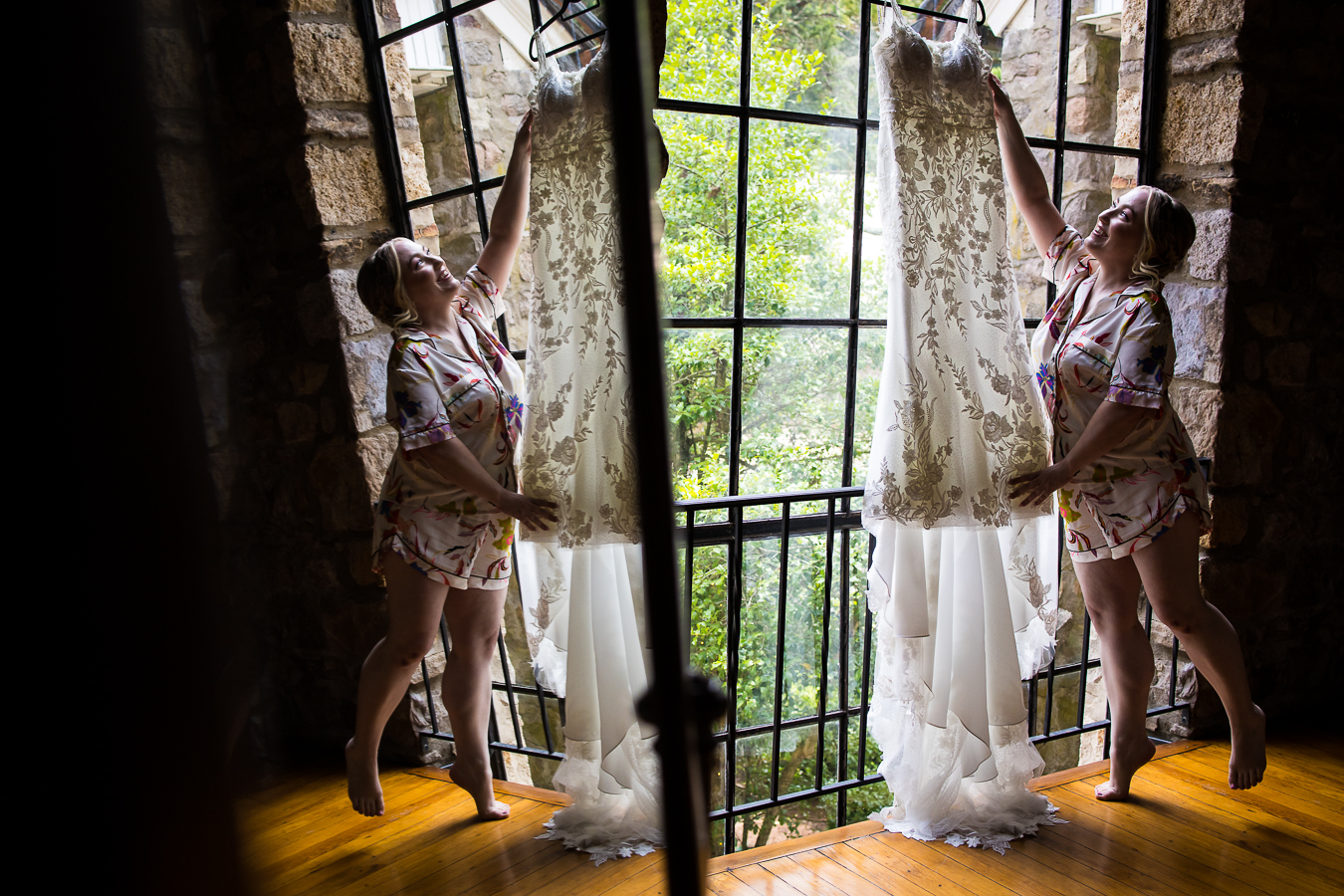 creative photographer, lisa rhinehart, captures this image of the bride as she reaches for her dress caught through the reflection in the mirror