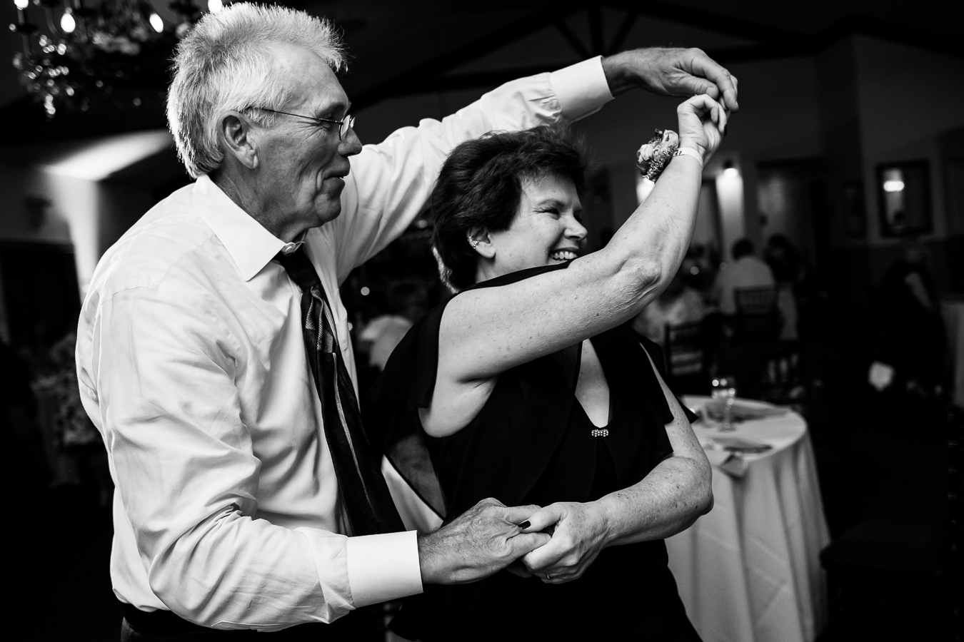 black and white image of guests as they spin each other around and dance during this new hope pa wedding reception 