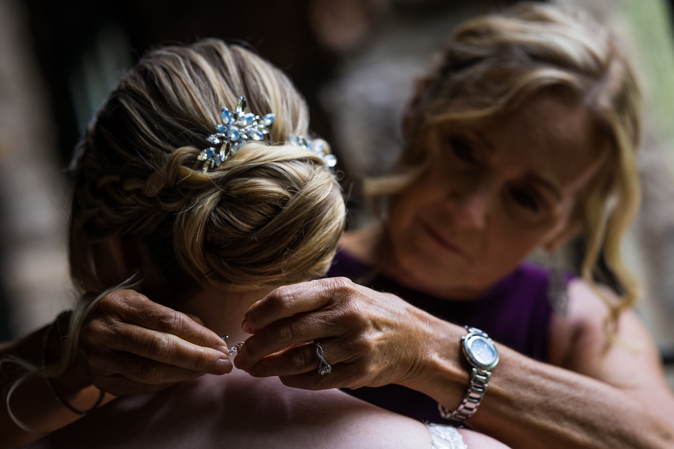 sentimental image of the mom putting her daughters necklace around her neck as she gets ready before her wedding ceremony in pa