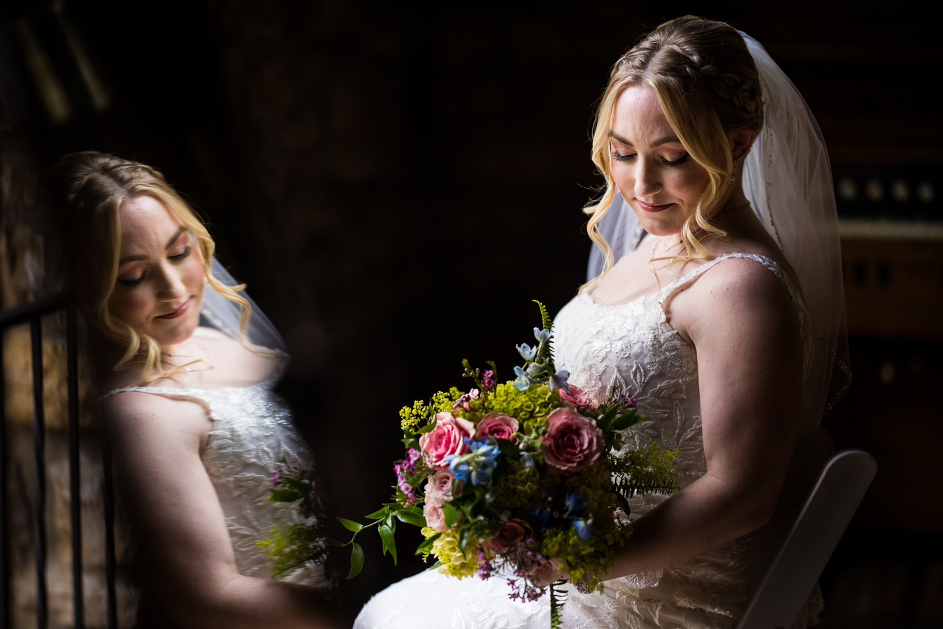 Holly Hedge Estate Wedding Photographer, lisa rhinehart, captures this unique, creative image of the bride as she looks down at her flowers and her reflection is caught in the mirror 