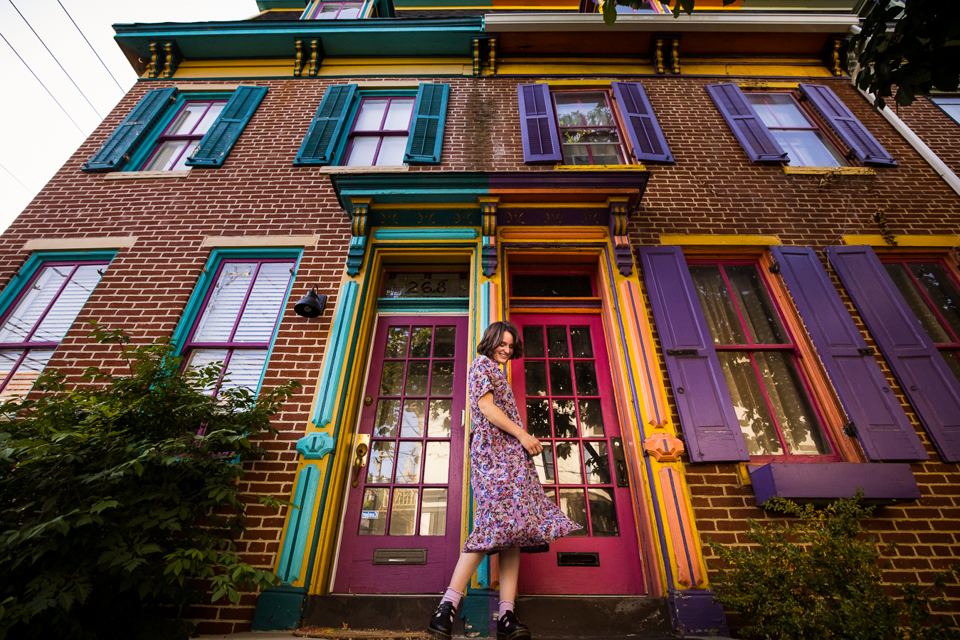 fun, colorful image of this artist as she explores the colorful vibrant downtown buildings in Harrisburg for this senior portrait session