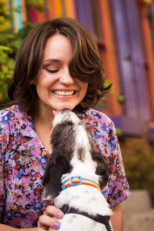 fun, playful image of this creative artist getting kisses from her dog during this Harrisburg portrait session