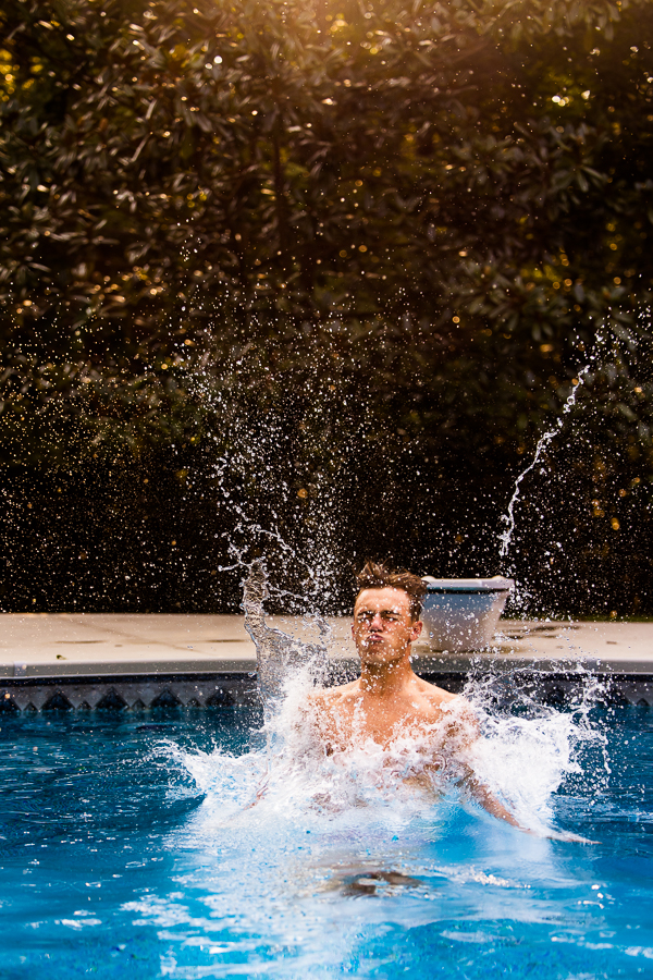 lisa rhinehart, captures this fun action shot as he cannon balls into his pool for this outdoor session