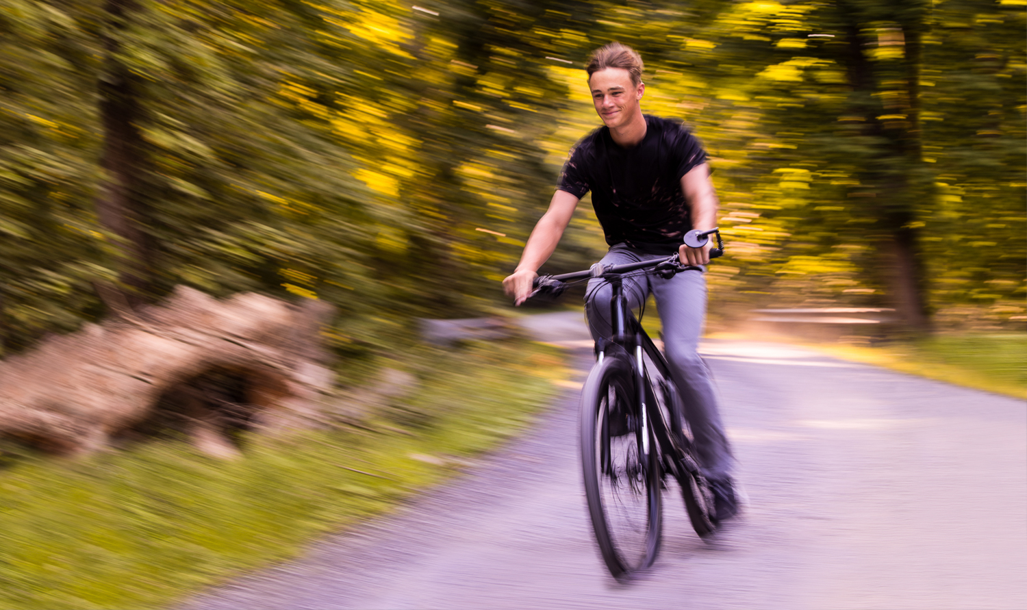 Creative Senior Portrait Photographer, rhinehart photography, captures this unique creative action shot of this senior as he rides his bike down an outdoor trail in shippensburg, pa 
