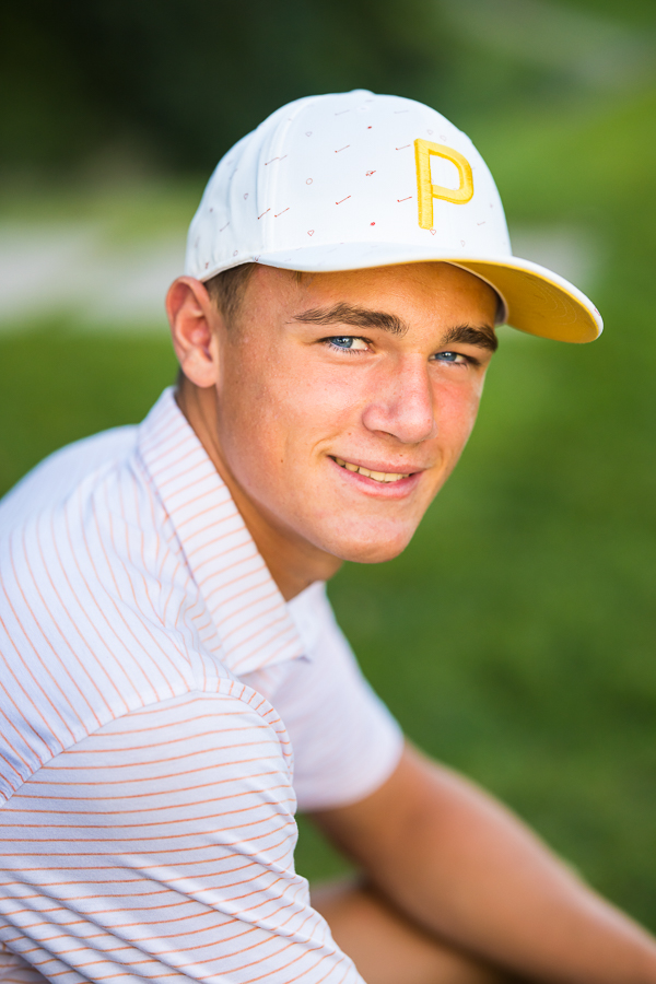 traditional image of this high schooler he sits at the golf course and smiles for the camera at the Chambersburg country club