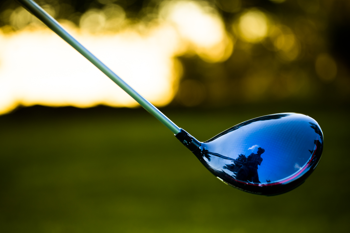 Creative Senior Portrait Photographer, rhinehart photography, captures this creative unique image of this senior as he holds his golf club captured through the reflection on his golf club at the Chambersburg country club 