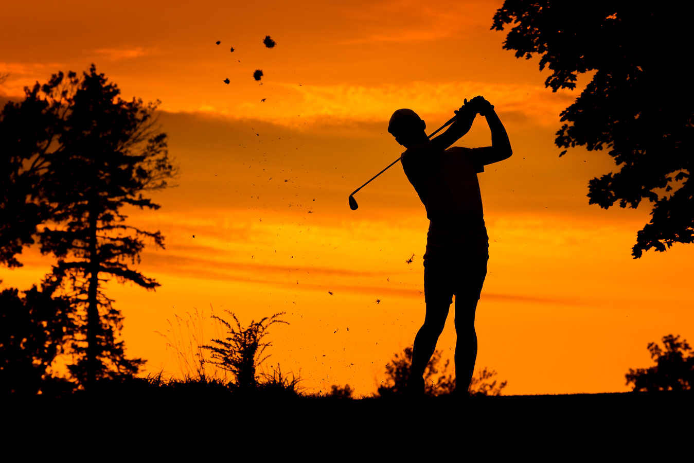 Creative Senior Portrait Photographer, rhinehart photography, captures this vibrant, colorful, unique silhouetted image of this senior as he golfs in Chambersburg for his outdoor senior portrait session 