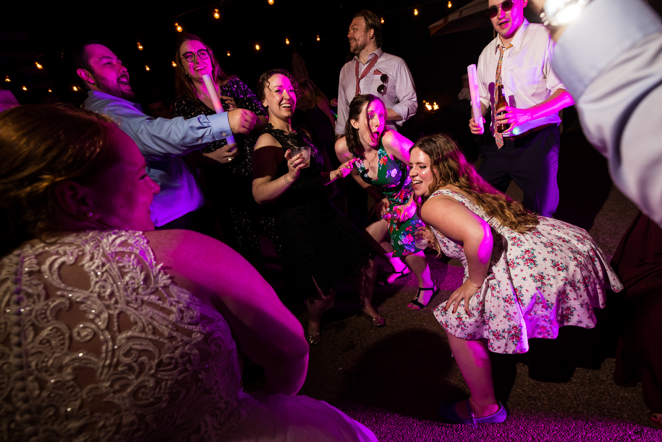 vibrant, colorful, fun image of guests dancing during this outdoor wedding reception captured by oak lodge's fun wedding reception photographer, lisa rhinehart