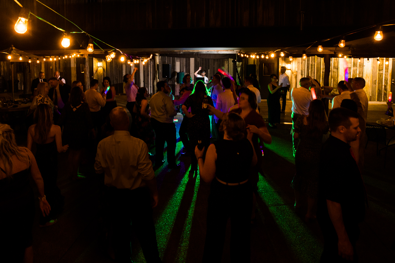 image of guests as they dance together during this outdoor wedding reception with DJ crush 
