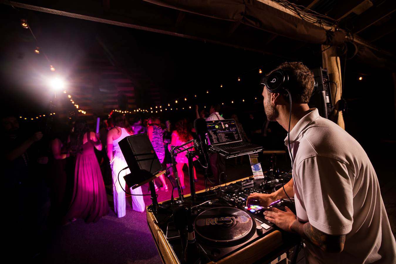close up image of dj crush as he gets the party going on this outdoor dance floor for this wedding reception at oak lodge in stahsltown pa 