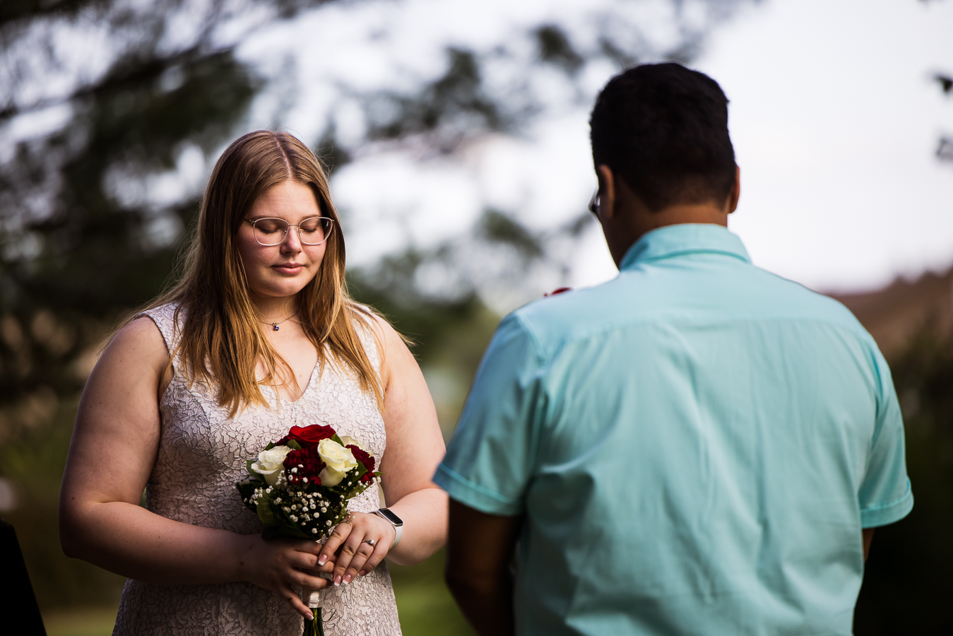 image of the couple as they stand facing each other saying a prayer during their intimate wedding ceremony in maryland