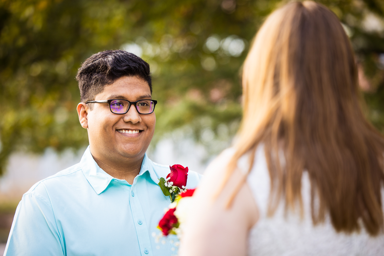 image of the groom with a huge smile on his face as he stares at his bride during their intimate wedding ceremony in spencerville Maryland at the cedar ridge community church