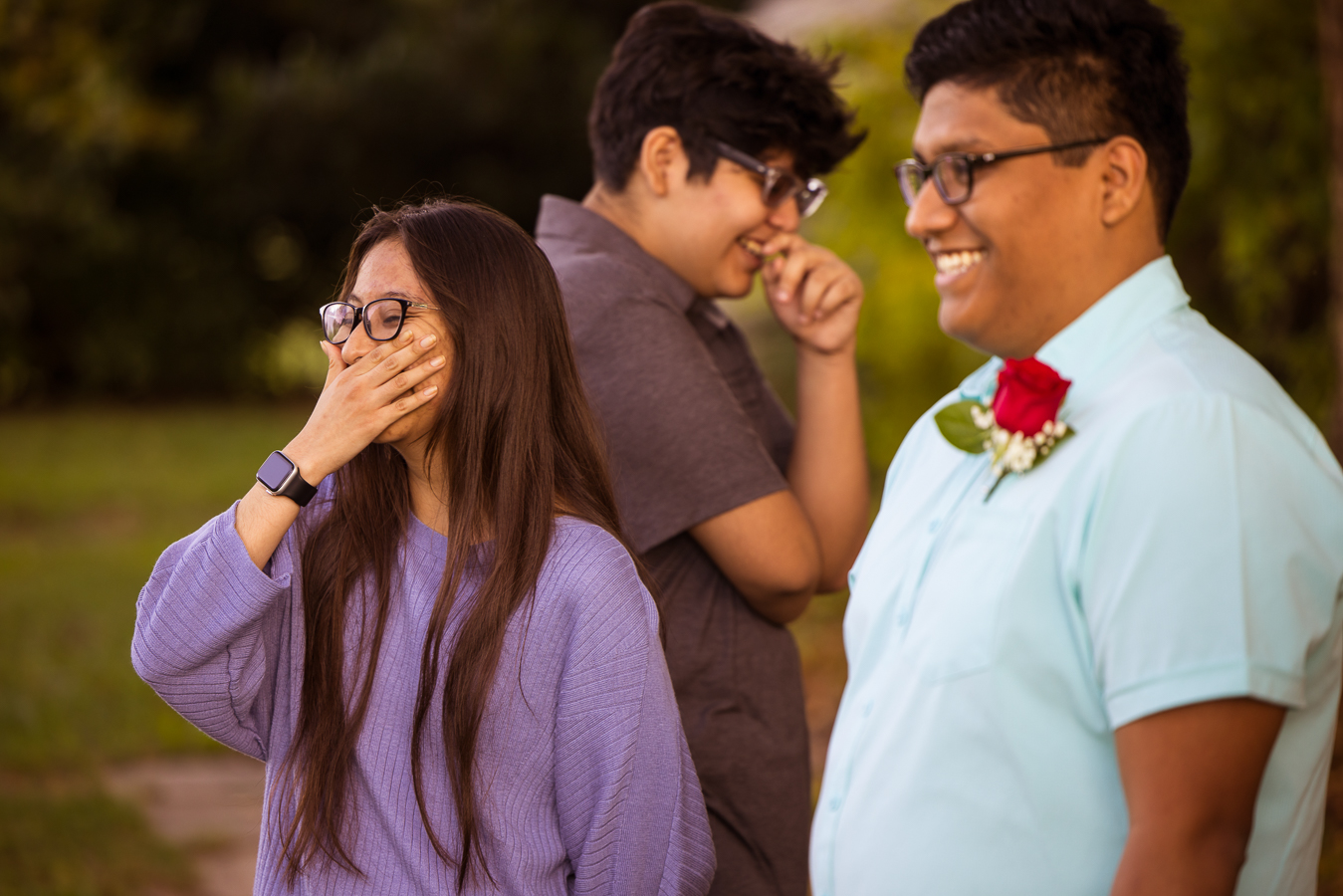 candid spencerville maryland wedding photographer, lisa rhinehart, captures this candid moment of the groom with his siblings as they all laugh at someone during the intimate wedding ceremony 