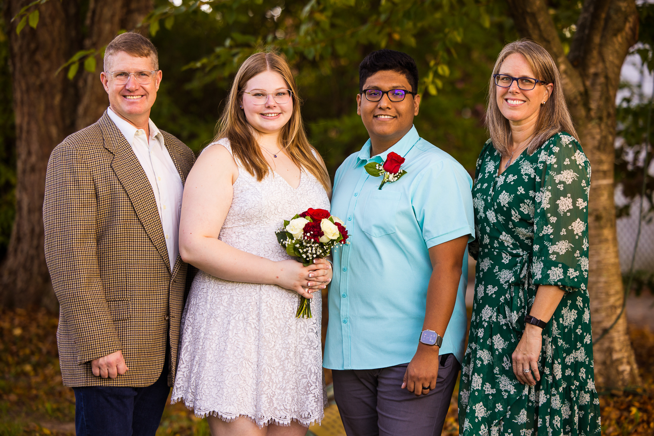 maryland family photographer, lisa rhinehart, captures this image of the couple with their parents for formal family portraits after their intimate wedding ceremony 