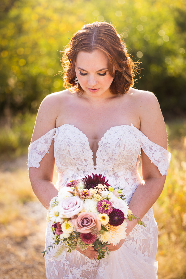 traditional portrait of this bride as she shows off her hair and makeup done by beauty by khara and her floral bouquet made by iron willow floral designs for this branding photography session