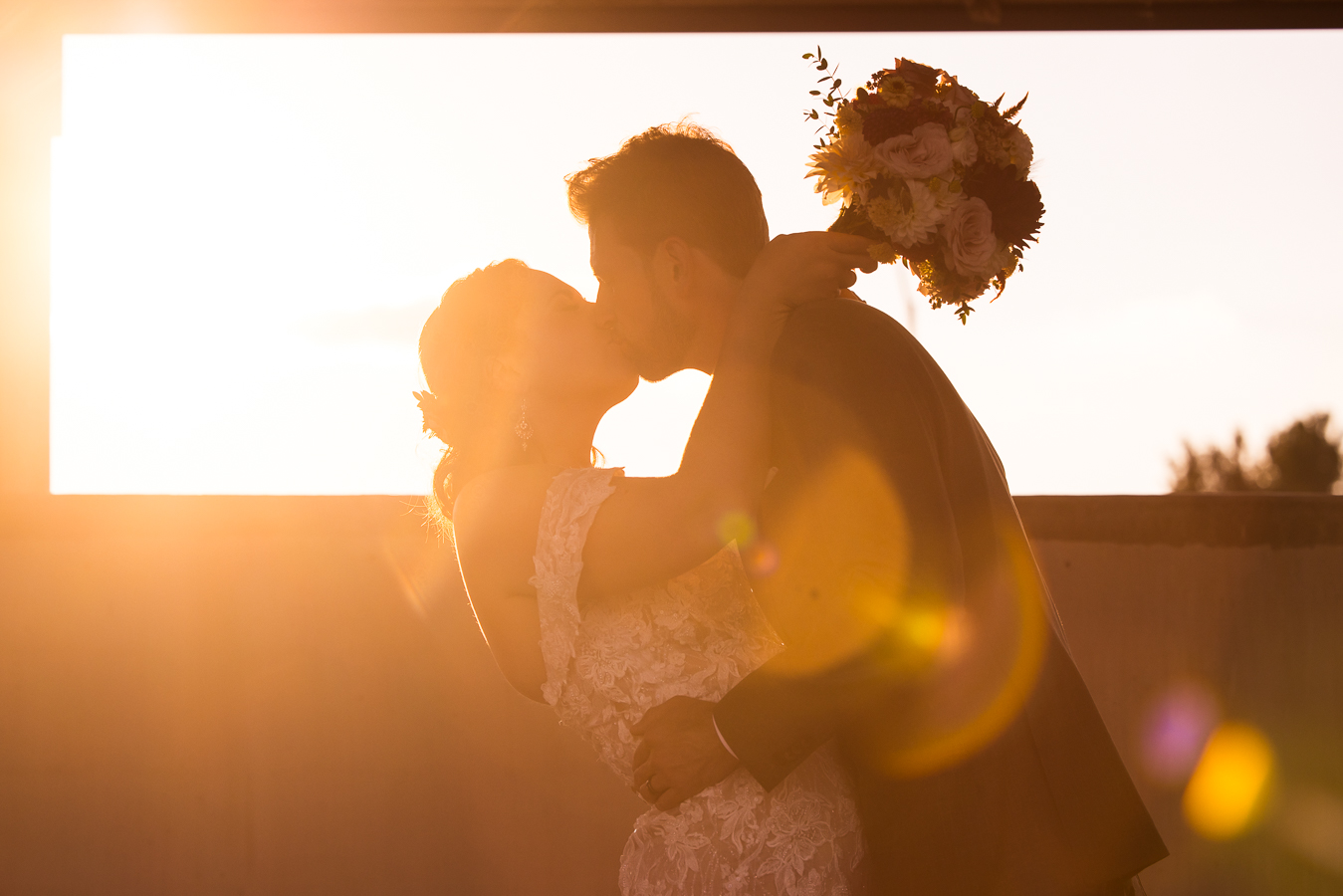 central pa wedding photographer, lisa rhinehart, captures this image of the bride and groom as they kiss each other during this golden hour sunset at alpine acres in warfordsburg, pa 
